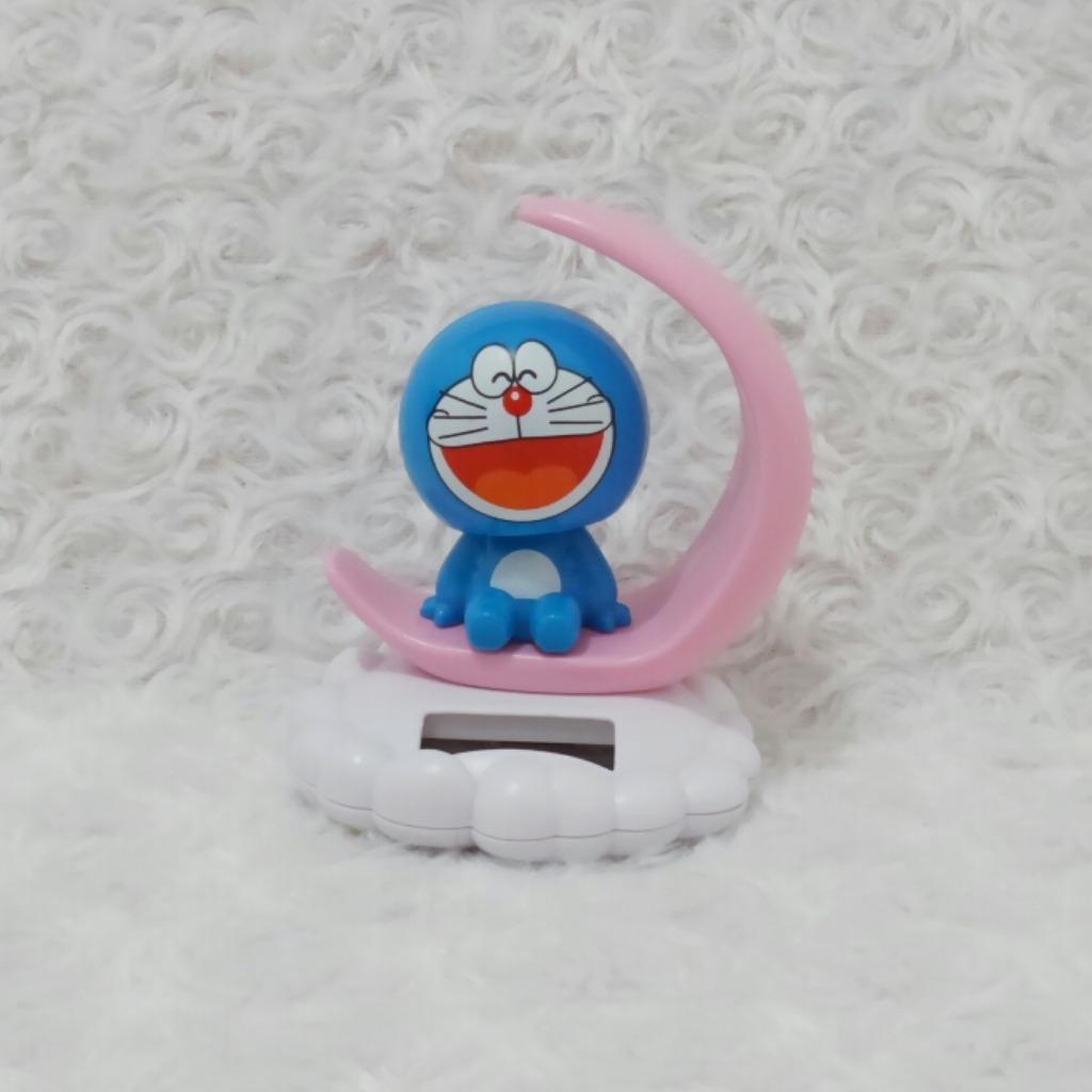 Boneka solar doraemon bulan senyum